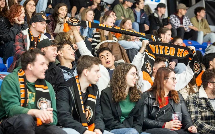 UNIted HK fans with a scarf in the stands of ČPP Aréna